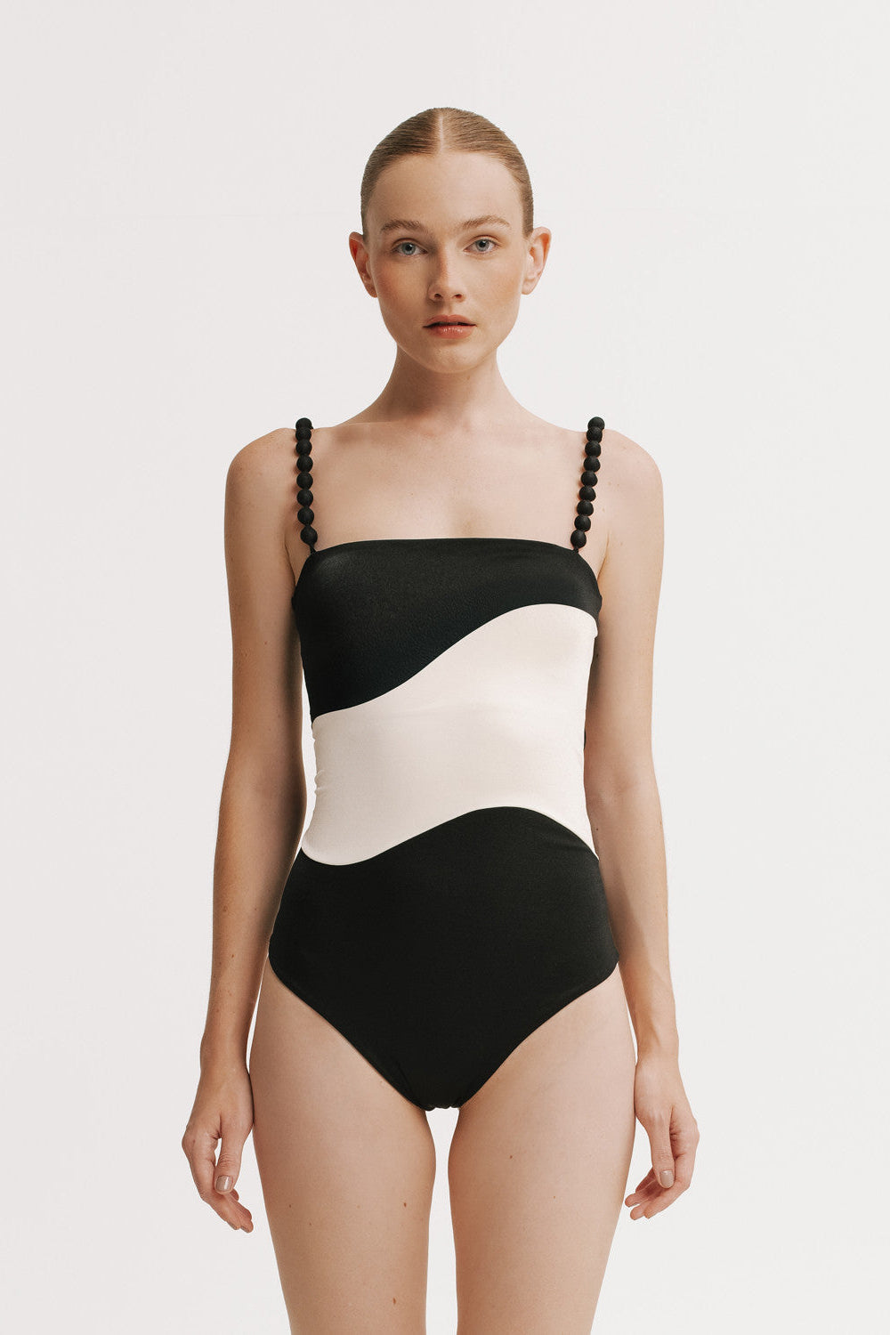 Front view of model wearing Black and white One Piece with contrast wave panel