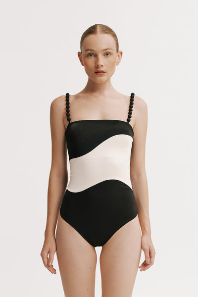 Front view of model wearing Black and white One Piece with contrast wave panel