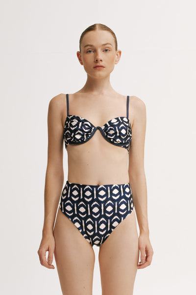 Front view of model wearing the Ruby Ikat high-waisted bikini bottom in navy ikat print