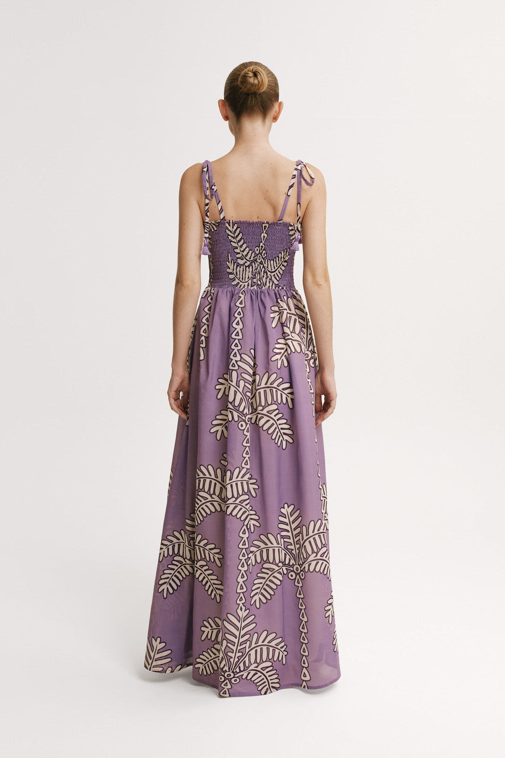 Purple evening gown with gold leaf pattern on a white background
