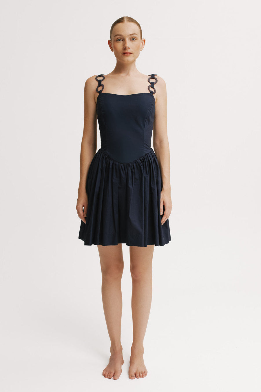 Front view of navy mini dress with structured bodice.
