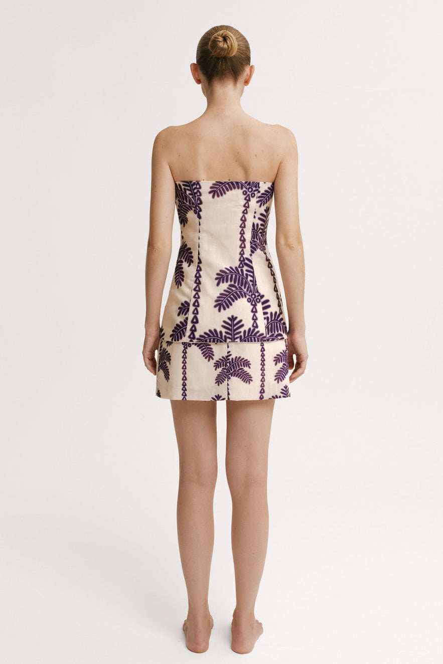 Back view of a model wearing a  top and Skirt mini length set with purple palm print – Resort 2026 resortwear.