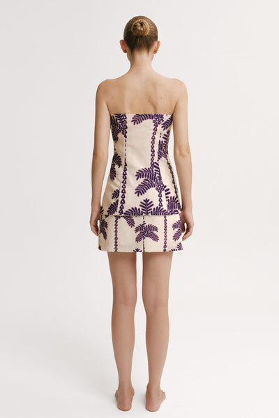 Back view of a model wearing a  top and Skirt mini length set with purple palm print – Resort 2026 resortwear.