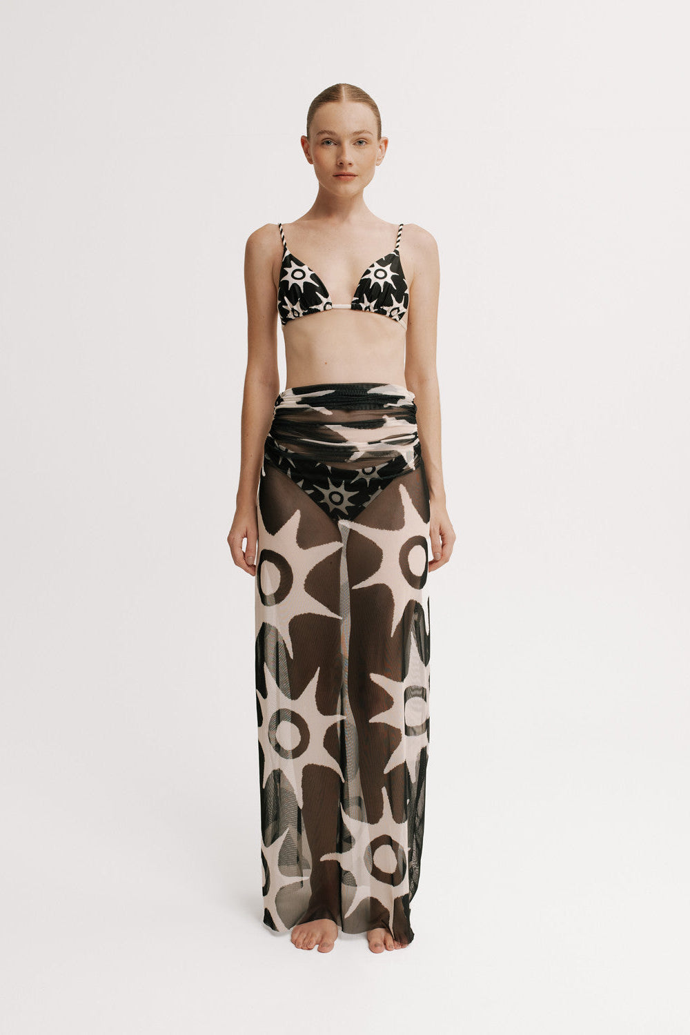 Front view of model wearing the Alma Solar Skirt with a matching solar-print bikini top.