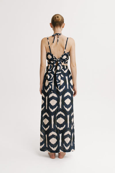 Back view showing adjustable back tie and tiered maxi skirt movement.