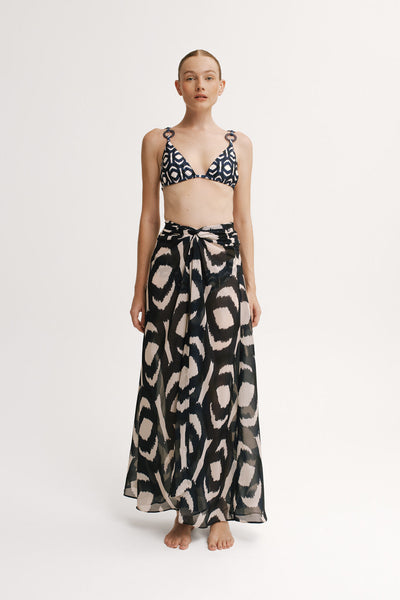 Model wearing sheer navy ikat wrap skirt styled over bikini.