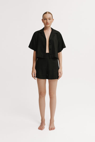 Person wearing a black outfit on a white background