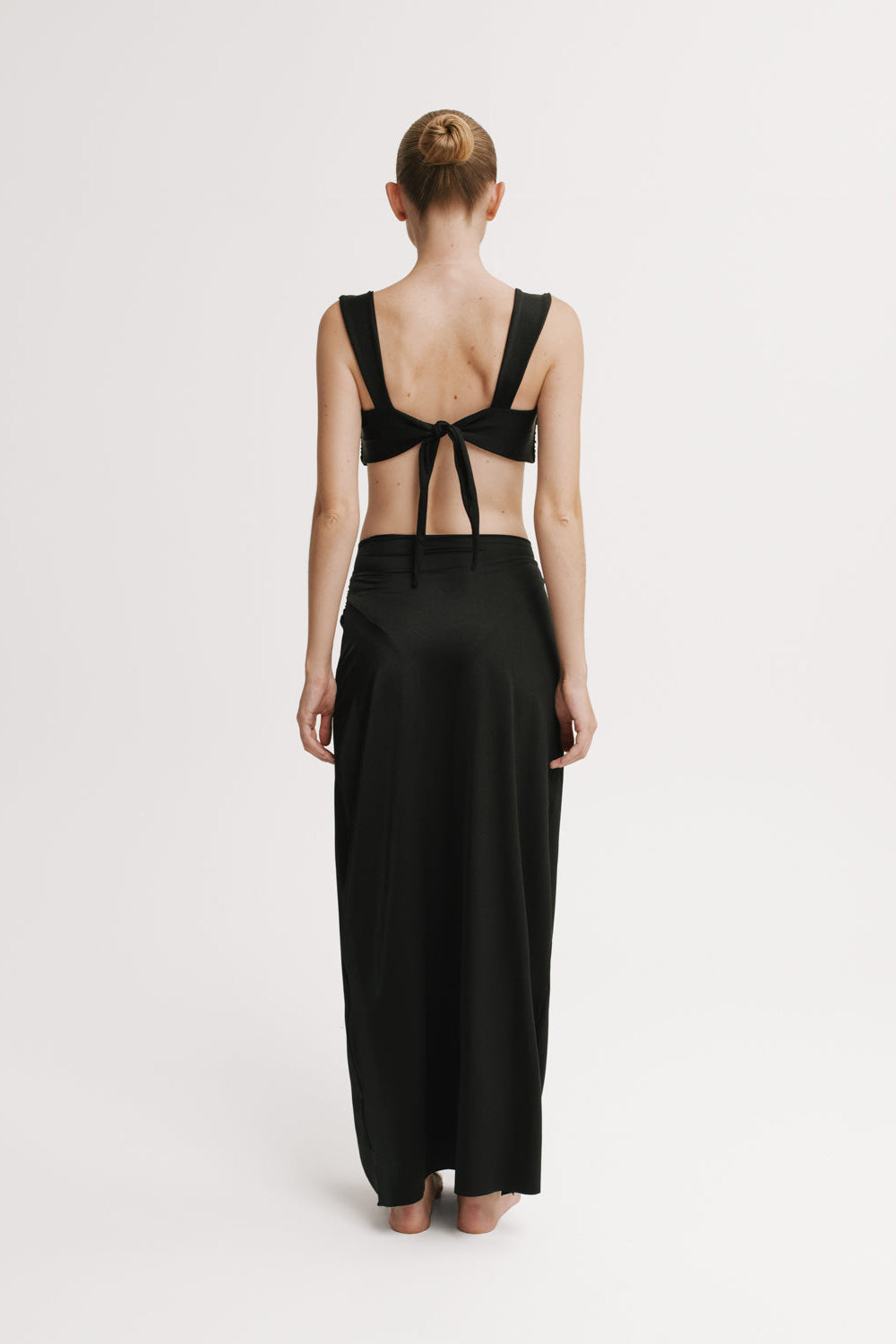 Back view of model wearing Black floor-length skirt