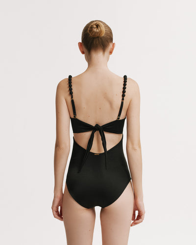 Back view of Black snd White One Piece with adjustable tie-back