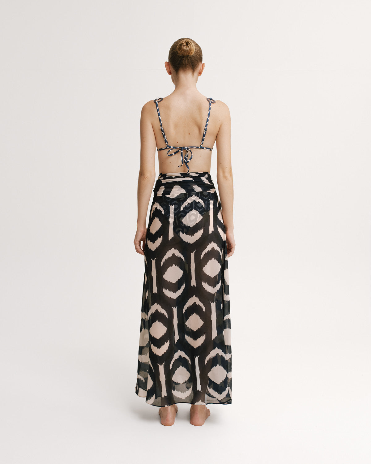 Back View of Full-length sheer printed skirt in navy ikat.