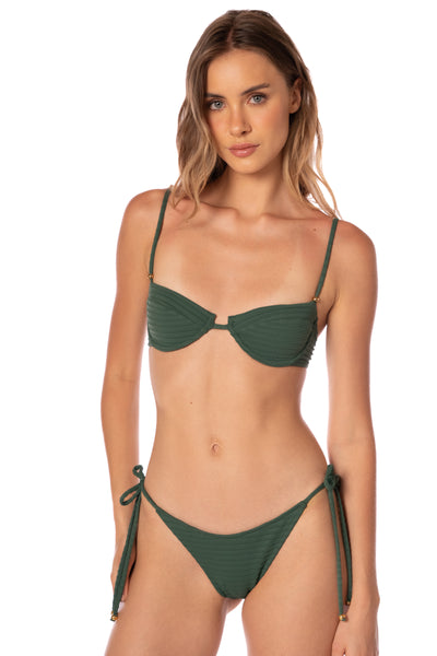 Woman wearing a green bikini set on a white background