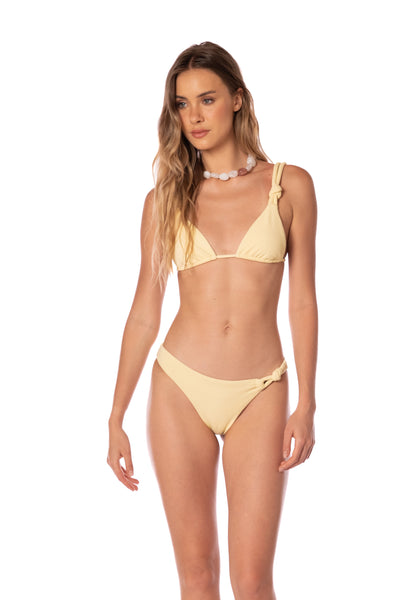Woman wearing a yellow bikini set on a white background