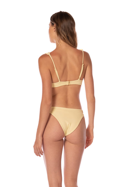 Woman wearing a beige bikini on a white background