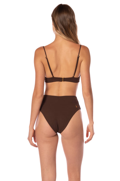 Woman wearing a brown bikini set on a white background