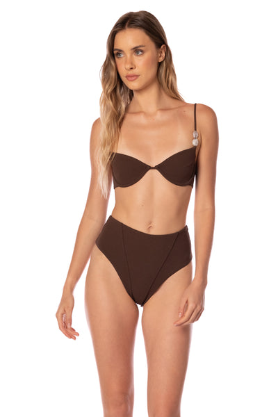 Woman wearing a brown bikini on a white background