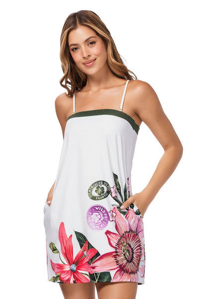 Woman wearing a white dress with floral designs on a white background