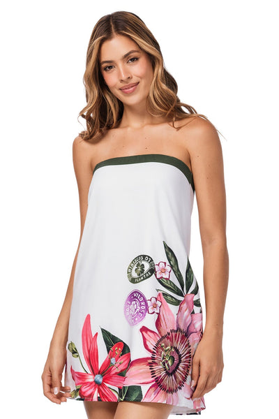 Woman wearing a strapless dress with floral designs on a white background