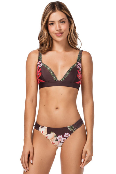 Woman wearing a floral bikini set on a white background